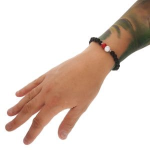 Bransoletka patriotyczna męska z lawy wulkanicznej, kuleczek srebra oraz jadeitu i howlitu założona na ręce. Jadeit i howlit symbolizują biało czerwone barwy Polski.