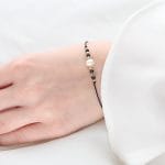 Minimalistyczna damska bransoletka srebrna pozłacana na czarnym sznurku z perłą SECRET