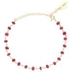 bransoletka damska srebrna pozłacana łancuszkowa z rubinem. Bransoletka posiada przedłużkę na której końcu zawieszona jest zawieszka z logo Rosett