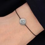 Bransoletka dla Lwa na sznurku z celebrytką. Bransoletka srebrna na czarnym sznurku na ręce