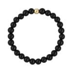 Złoty pierścionek elastyczny z kuleczką złota i czarnym onyksem